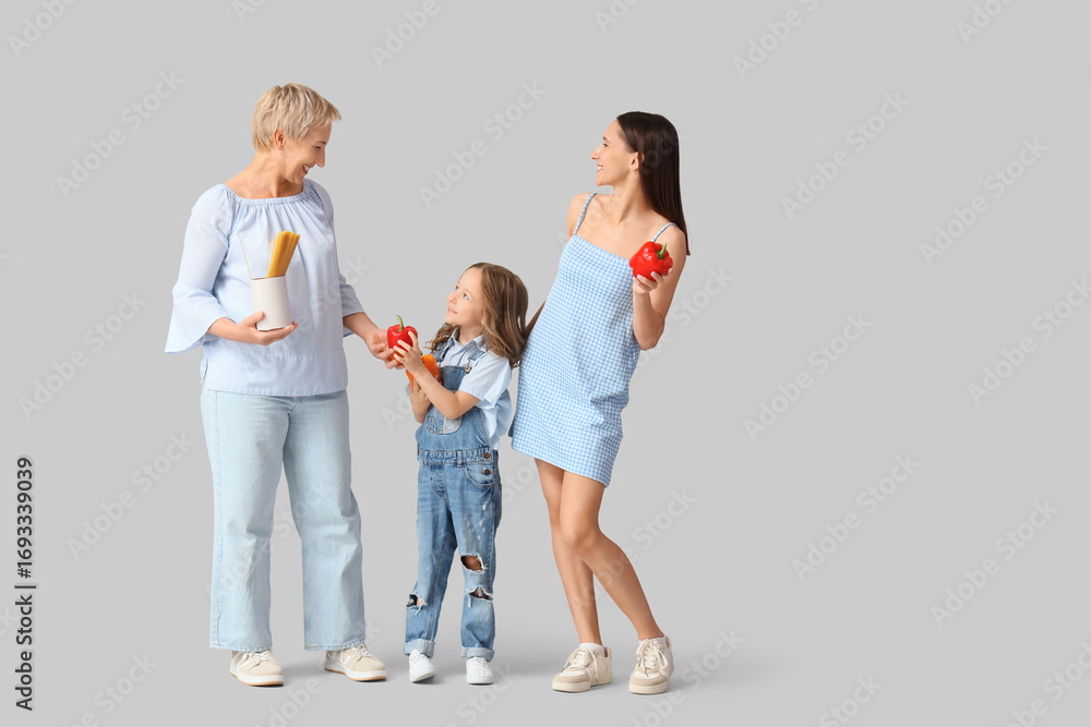 Fototapeta premium Happy family with pasta and bell peppers on light background