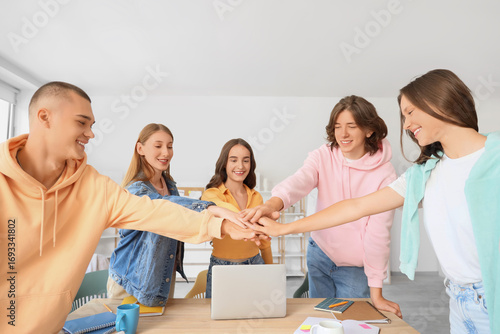 Group of students putting h...