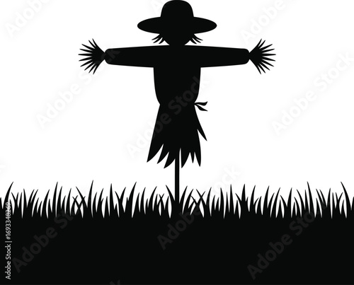 Silhouette scarecrow in grassy field black white