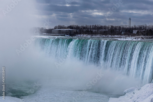 A stunning winter view of Niagara Falls,  Canadian Horseshoe Falls, dramatic winter landscape at Niagara Falls, Ontario, Canada