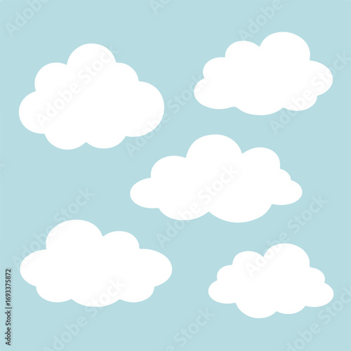 Fluffy white clouds floating in a light blue sky
