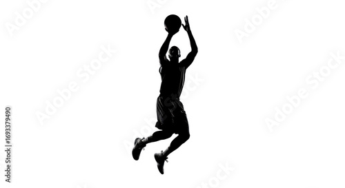 Dramatic silhouette of basketball player mid-air reaching for the ball during game moment