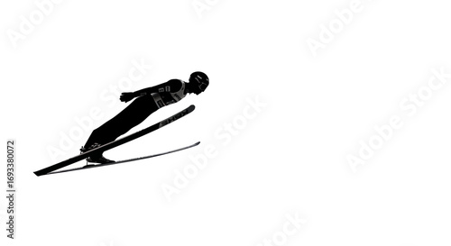 Silhouette of a skier in mid-air during a ski jump showcasing athleticism and skill