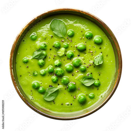 Green pea soup with basil and pepper in bowl top view isolated  
