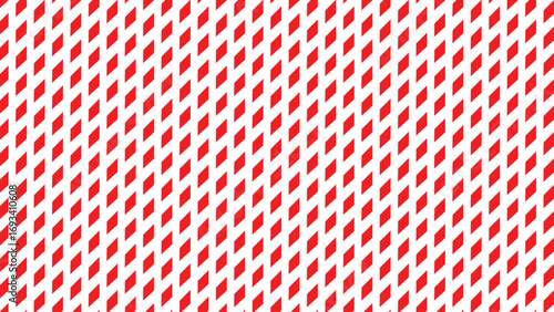 Close up of a red and white striped paper straws arranged in a repeating diagonal pattern