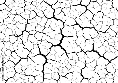 Abstract pattern of dry cracked earth texture in black and white monochrome close up