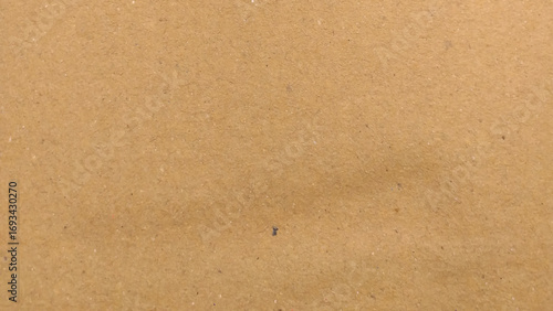 Abstract pattern of beige rough carton, old paper sheet, parchment or papyrus surface, Background of brown kraft paper or cardboard texture.