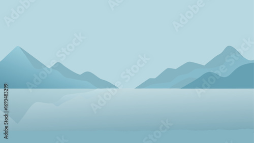 Mountains reflecting on light blue water