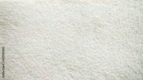 White soft woolen texture background, close-up of light-colored felt fabric.