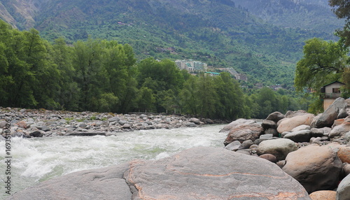 indus river's important tributary beas river flowing through the beautiful lush green mountain valley in kullu district of himachal pradesh, india