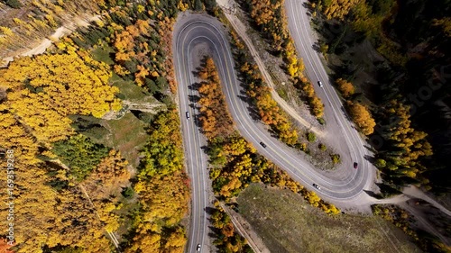 Top Down Aerial of Winding Mountain Road Through Colorado Fall Foliage