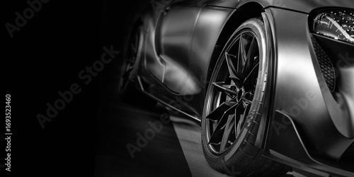 Front view of LED headlights sport car on black background