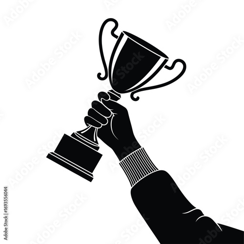 Hand holding a trophy in celebration of victory and achievement
