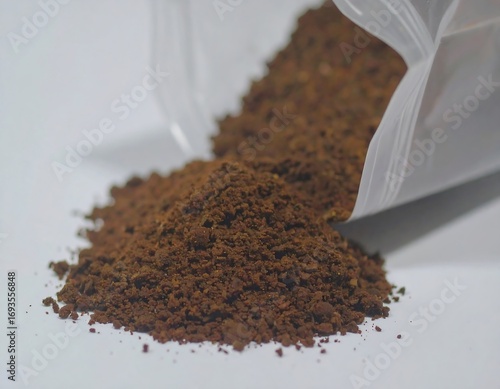 Ground coffee spilling from a bag