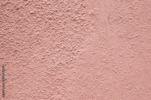 Close-up of the texture of rough, worn plaster.