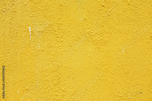 Vintage rough grained yellow plaster.