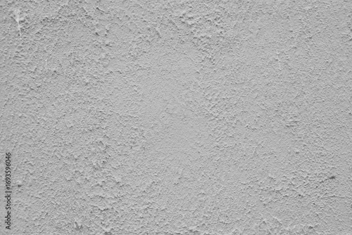 Distressed grey plaster on a concrete wall.