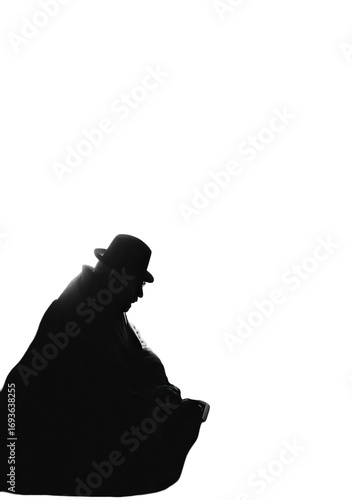 Silhouetted figure, hunched over, dark background