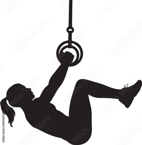 Silhouette of a strong fitness athlete performing an exercise on gymnastic rings