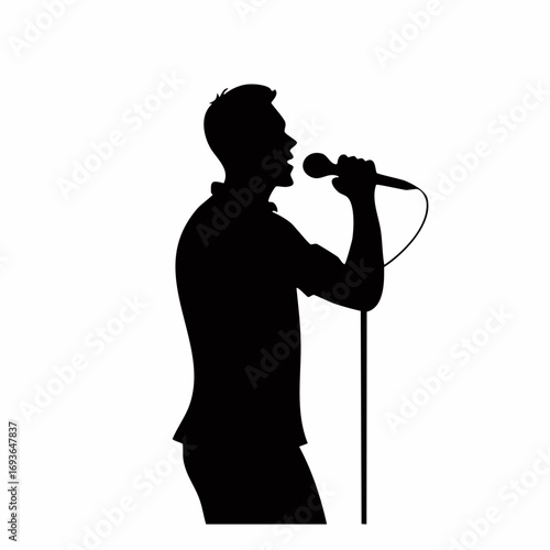 Dynamic male vocalist belts out a powerful song on stage, captivating a crowd with electrifying performance.