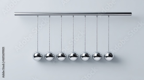 Newton's Cradle with Seven Silver Spheres on a Light Gray Background