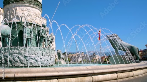 Fountain in the center of Macedonia Square in Skopje with the North Macedonia flag in the background