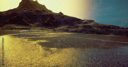 Tablou pe pânză A winding road leads through a rugged mountainous terrain