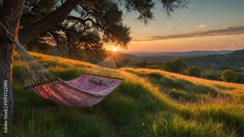 Serene sunset view of a hammock swaying gently between trees in a lush green landscape