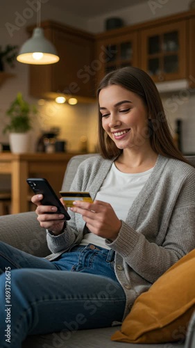 Happy woman paying online with a mobile phone and credit card. Vertical footage