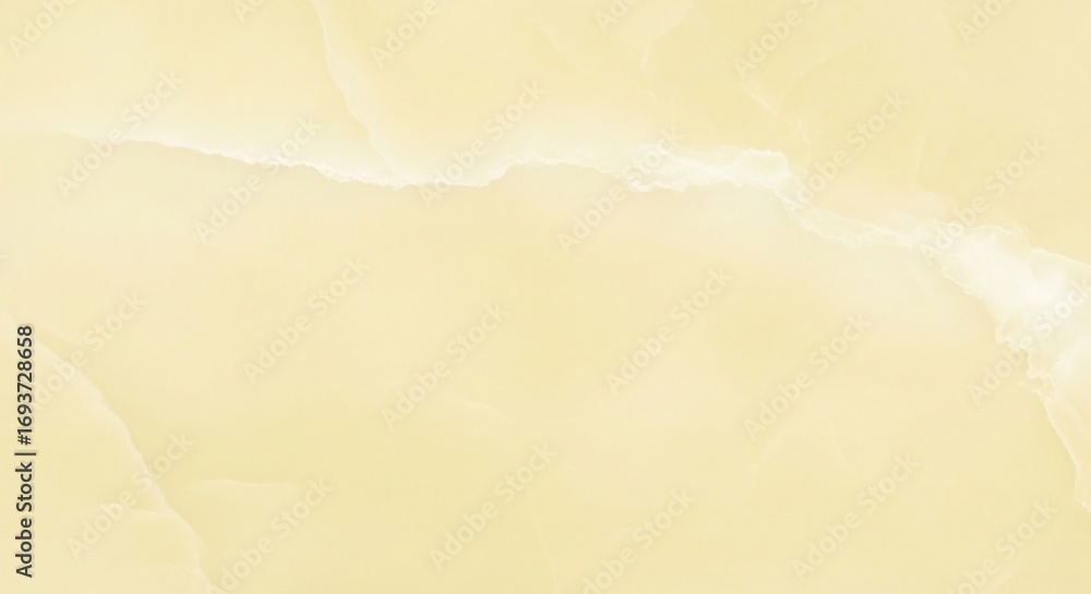 Obraz premium Close-up of a light yellow marble slab with subtle veining.
