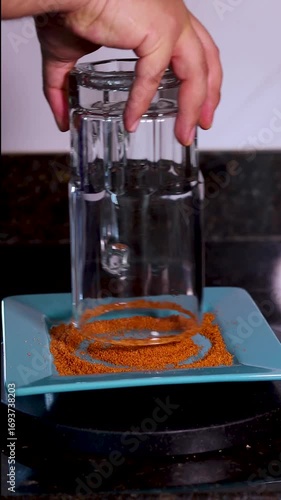 Bartender frosting a beer glass with chili powder on a plate