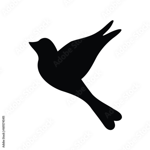 Silhouette of a flying bird in black against a white background space