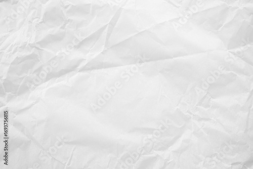 White crumpled paper texture background. Ideal for presentations and branding. Artistic projects that require a realistic recycled paper effect with subtle folds and wrinkles.