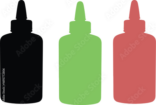 Three bottles of condiment, sauce, or similar liquid, in black, green, and red.