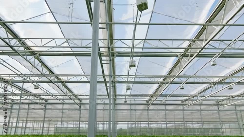 Wallpaper Mural Interior view of a greenhouse, showcasing its metal framework and translucent roof panels Torontodigital.ca