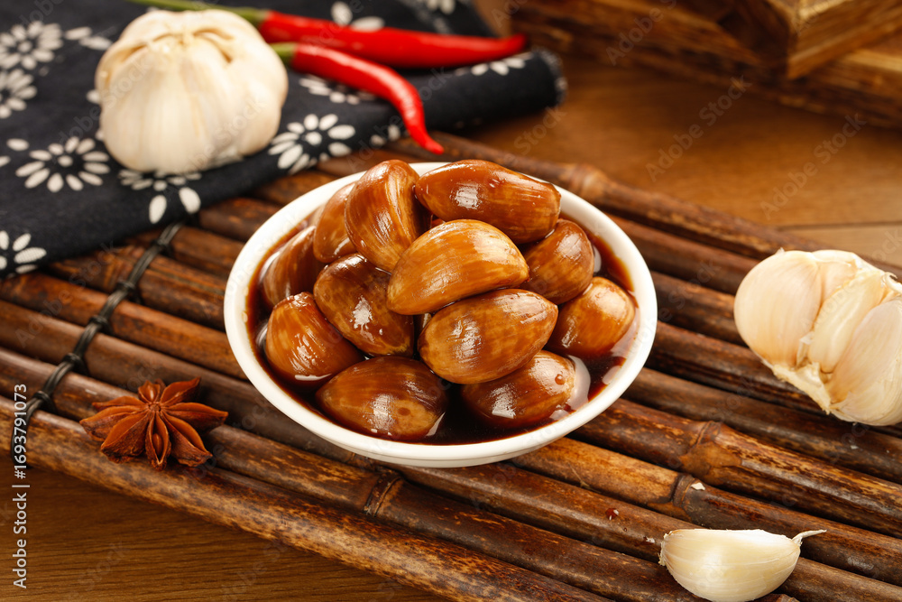 Fototapeta premium Traditional Chinese Braised Chestnuts in Sauce - Guangxi Regional Cuisine Side Dish with Garlic and Spices