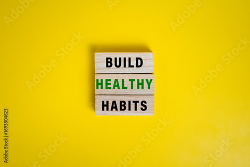 build good habits words symbol on wooden blocks isolated on yellow background. motivational words concept