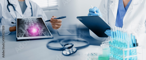 doctor working with examining x-ray and test tubes with liquid in laboratory, medical technology and scientist concept.