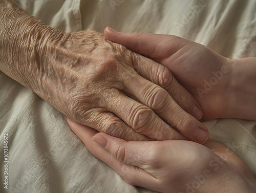 Doctor is holding a hand of elderly woman patient in palliative care medicine clinic or hospice	
