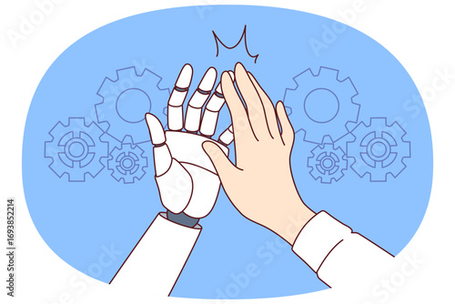 Collaboration man and AI robot making high-five gesture after successfully completed task. Hands of business manager and humanoid helping to develop production thanks to AI or artificial intelligence