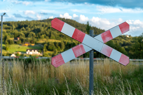 Fototapeta Naklejka Na Ścianę i Meble -  St. Andrew's Cross at the old railway line no. 104 with the Beskid Wyspowy mountain range in the background
