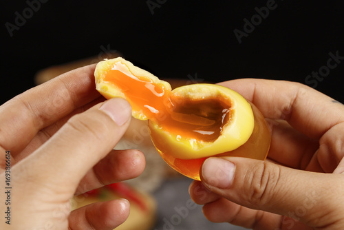 Fotografie Soft-Boiled Egg with Runny Yolk Held in Hands - Perfect Golden Center