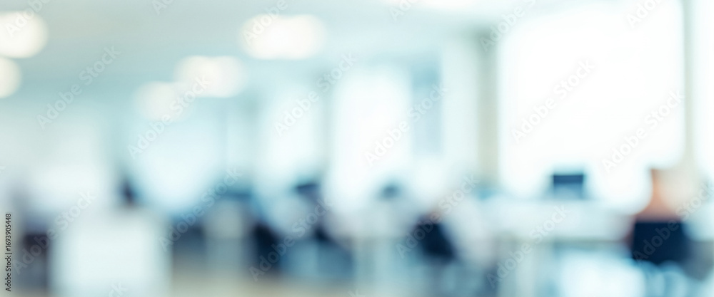 Fototapeta premium Blurred office space with people working at desks in a bright environment, shapes dissolving into a dreamy airy ambience filled with soft glowing serenity.