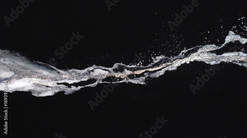 Wallpaper Mural Close-up of a wave or splash on a black background. the wave appears to be made up of small white particles that are splashing and creating a dynamic and dynamic pattern. Torontodigital.ca