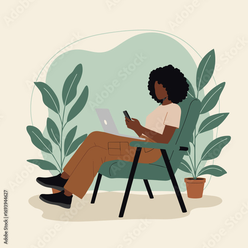 African American woman working remotely from home, multitasking with laptop and smartphone in a comfortable, green environment. Modern work-life balance.