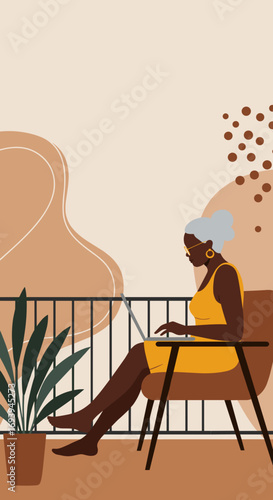 Senior Black woman working remotely on a laptop from her home balcony, embracing a productive and flexible digital lifestyle. Ideal for themes of modern work.