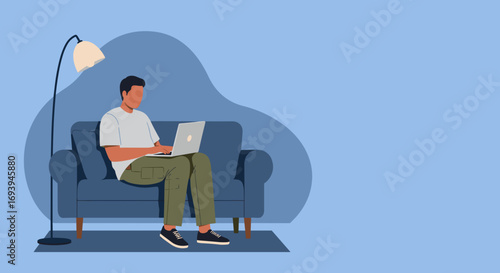 Casual man using a laptop on a comfortable sofa at home, depicting remote work, online learning, or a relaxed digital lifestyle.