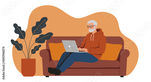Modern senior man works on a laptop from his comfortable home sofa, reflecting remote work, digital lifestyle, and leisure time.