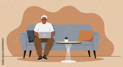 Senior man working on laptop from a comfortable sofa at home. Represents remote work, digital literacy, and modern relaxed lifestyle.