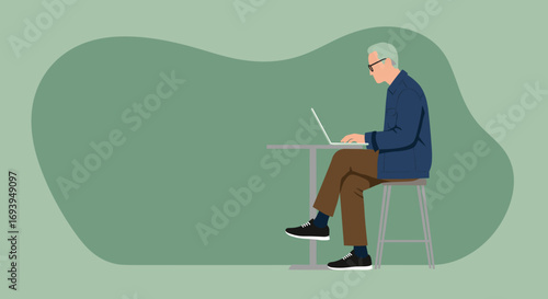 Senior man with glasses focused on working or learning on a laptop at a table. Represents digital engagement, remote work, and modern senior lifestyle.